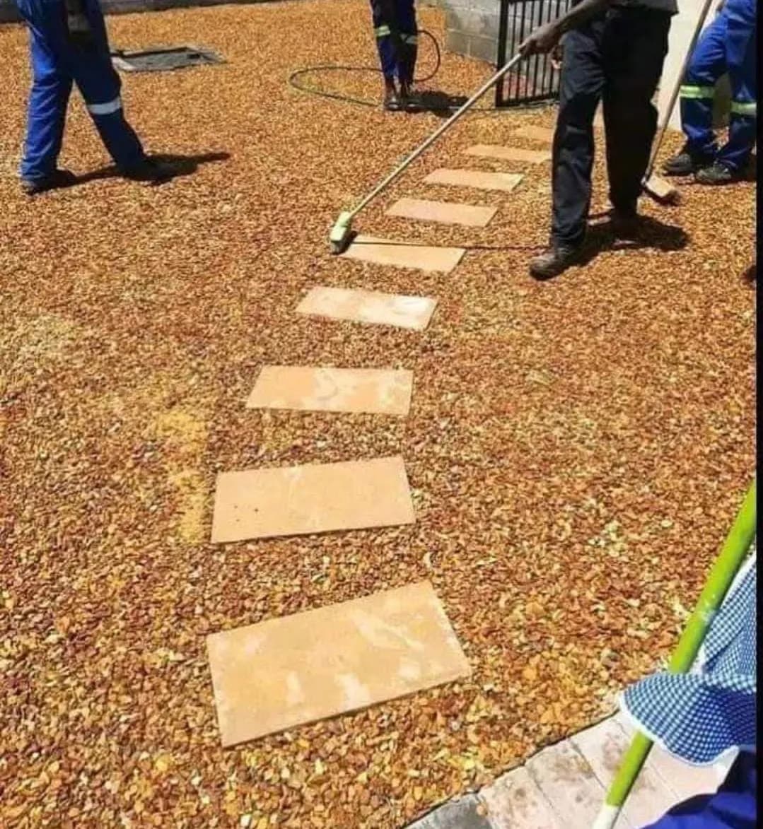Stepping stones being set into brown pebbles