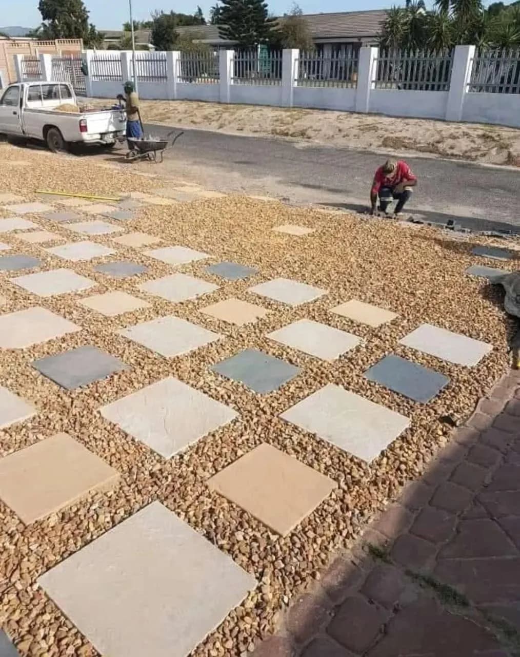 Square pavers set in brown pebbles