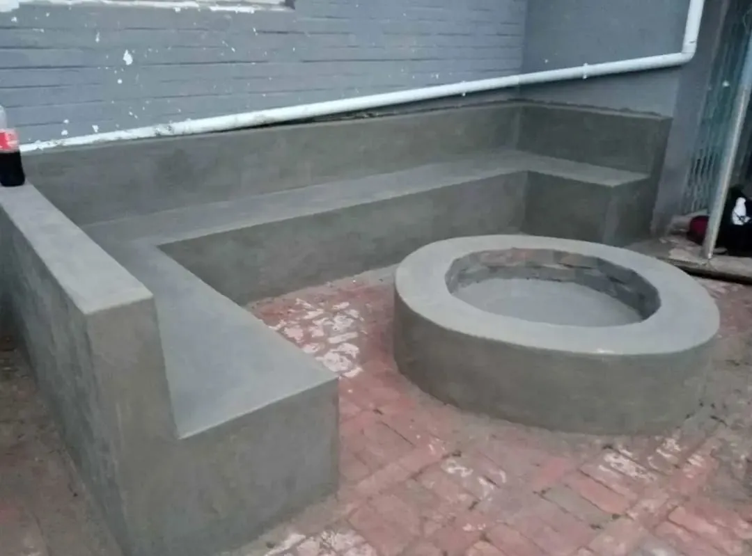 Built-in plastered seating around a round fire pit