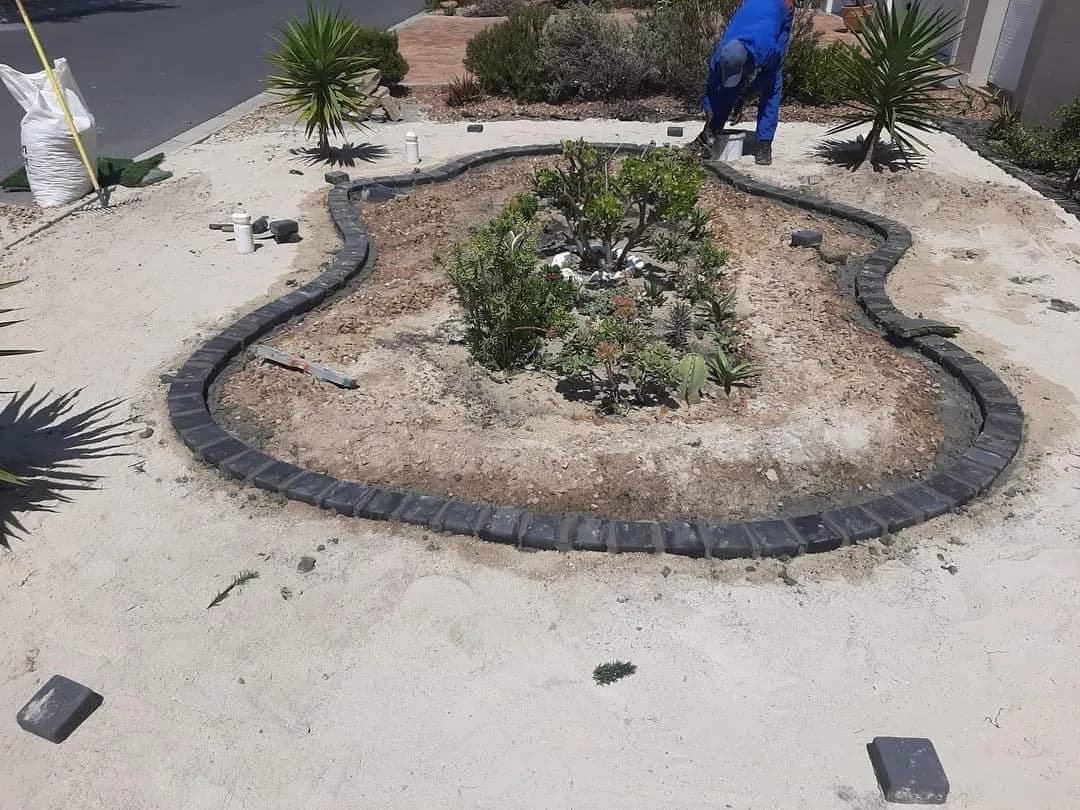 Before: Curved feature bed edged with pavers during groundwork