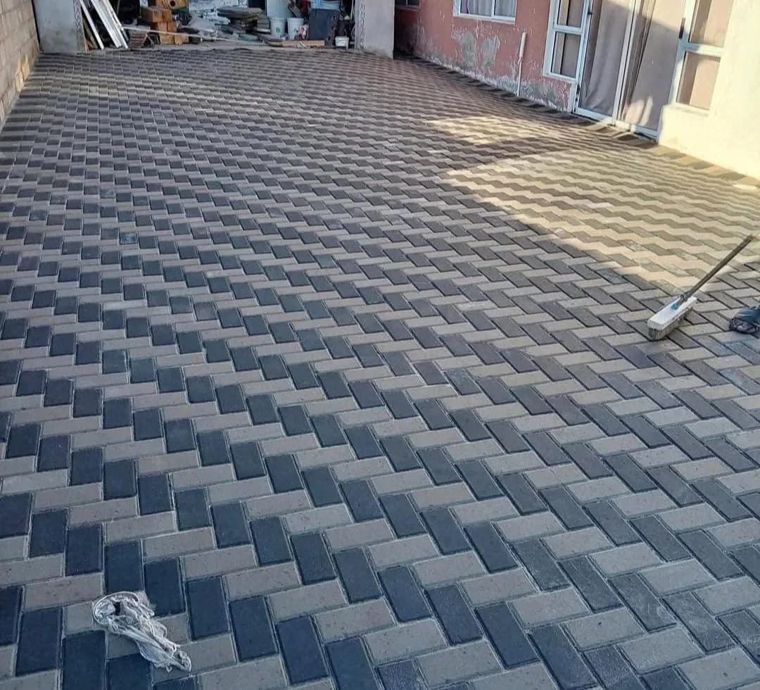 Grey and charcoal herringbone paving