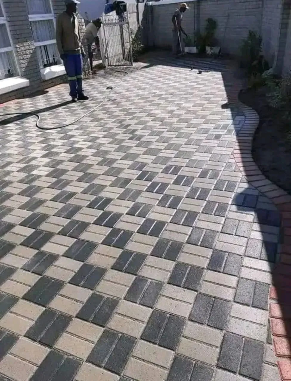 Grey and charcoal paving in a woven pattern