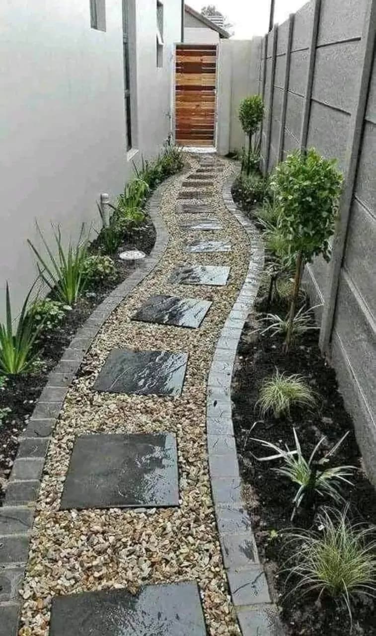 Winding pebble path with charcoal stepping stones and edging