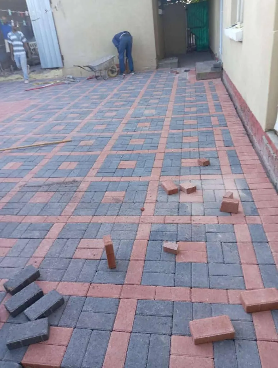 Charcoal paving with red brick grid detail
