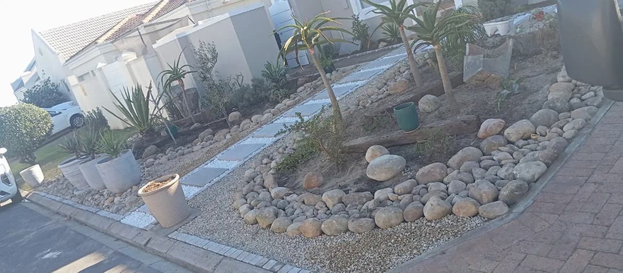 Garden path with river-stone bed and paver edging
